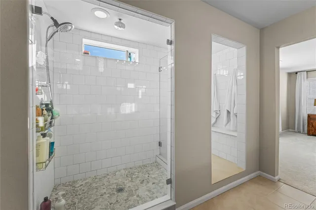 a bathroom with a glass shower door