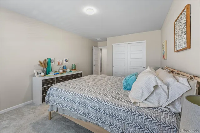 a bedroom with a bed and dresser