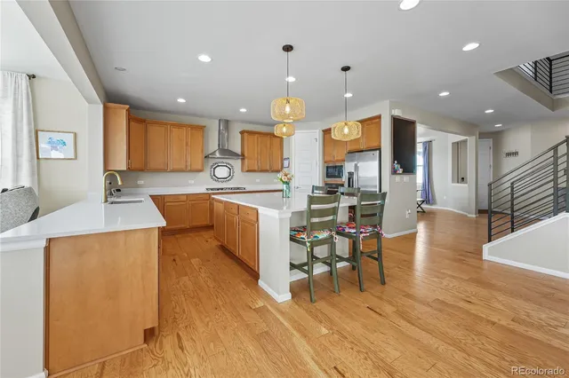 a large kitchen with a table and chairs