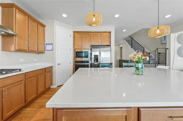 a kitchen with wooden cabinets and center island