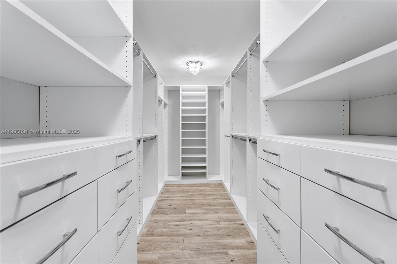 7225 Promenade Drive, Unit 102 Boca Raton, FL 33433 - Photo 11 of 18 a hallway with white cabinets and stairs