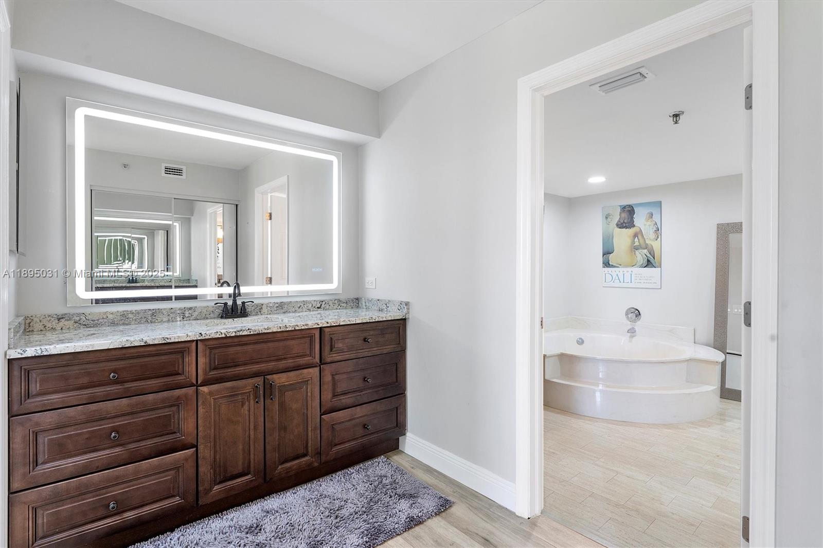 7225 Promenade Drive, Unit 102 Boca Raton, FL 33433 - Photo 12 of 18 a spacious bathroom with a tub sink and mirror