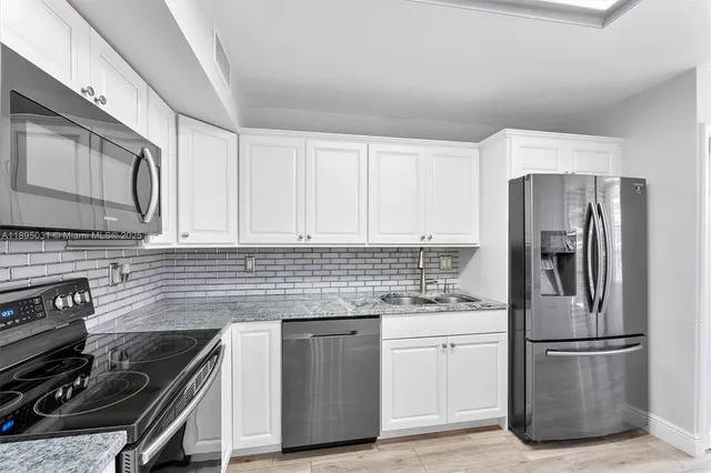 a kitchen with a stove microwave and a refrigerator