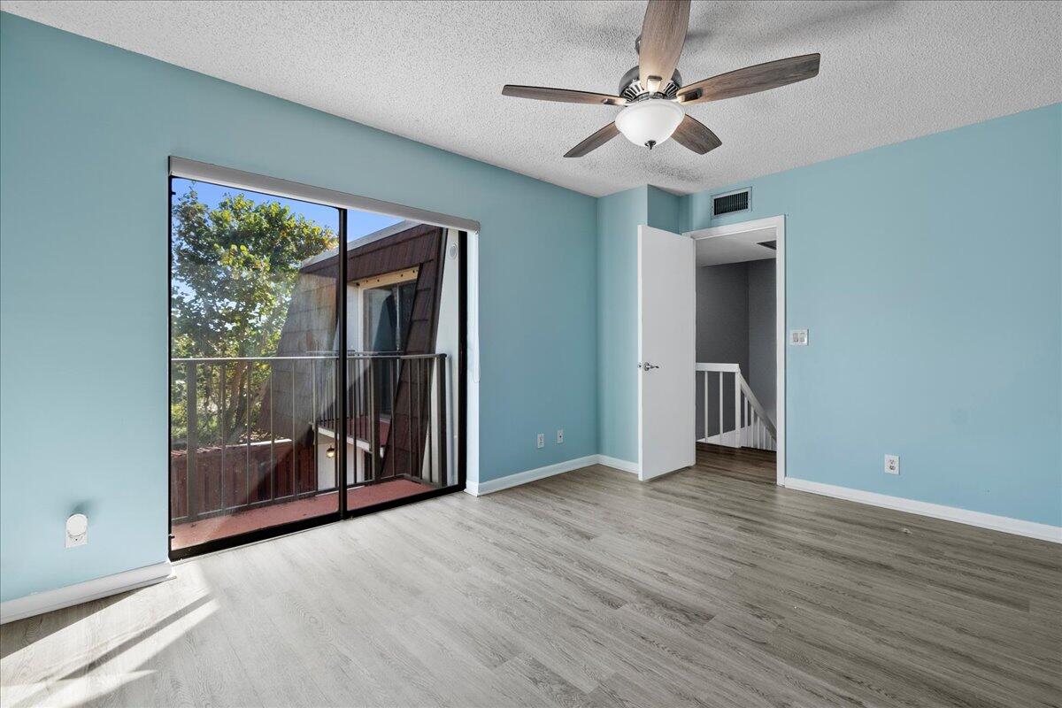 6038 Southeast Riverboat Drive, Unit 716 Stuart, FL 34997 - Photo 15 of 28 wooden floor in an empty room with a window