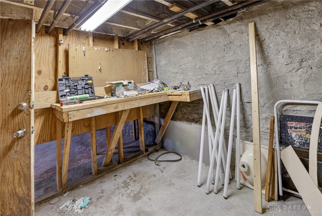 7045-7049 Montgomery Road Cincinnati, OH 45236 - Photo 64 of 68 This functional basement space features a practical workbench, ideal for projects and storage.