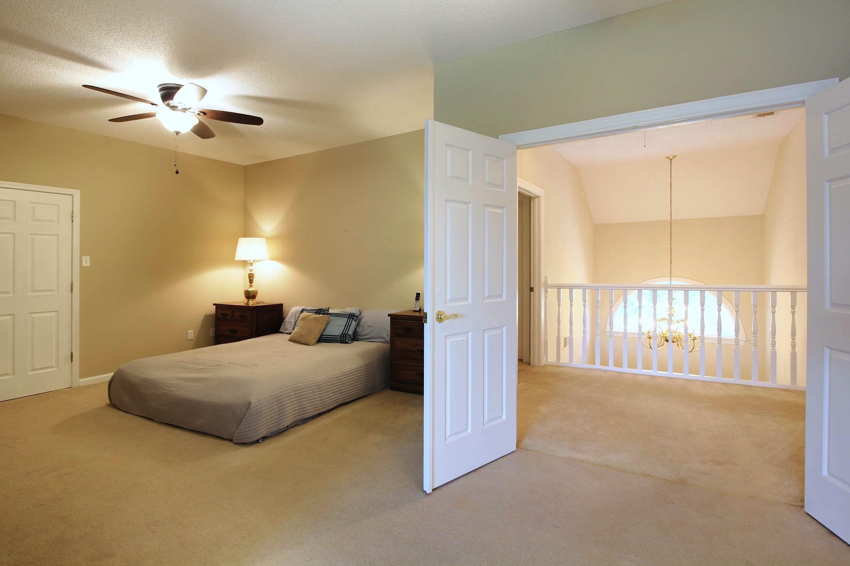 2550 North Reid Hooker Road Eads, TN 38028 - Photo 24 of 32 a bedroom with a bed and a chandelier