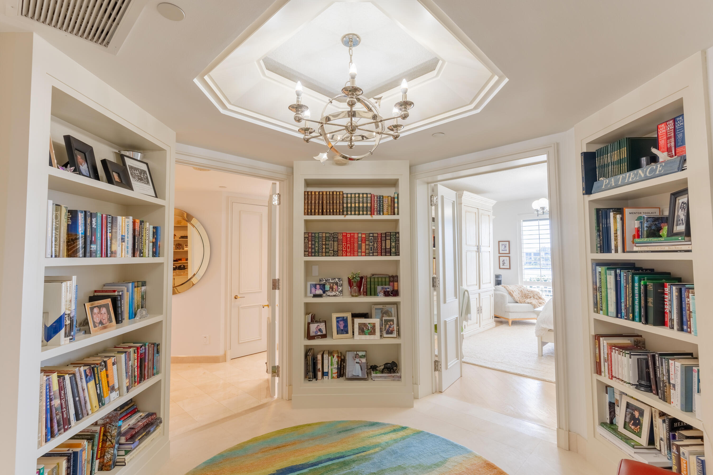 19950 South Beach Road, Unit 4 Tequesta, FL 33469 - Photo 19 of 56 a living room with furniture and a book shelf