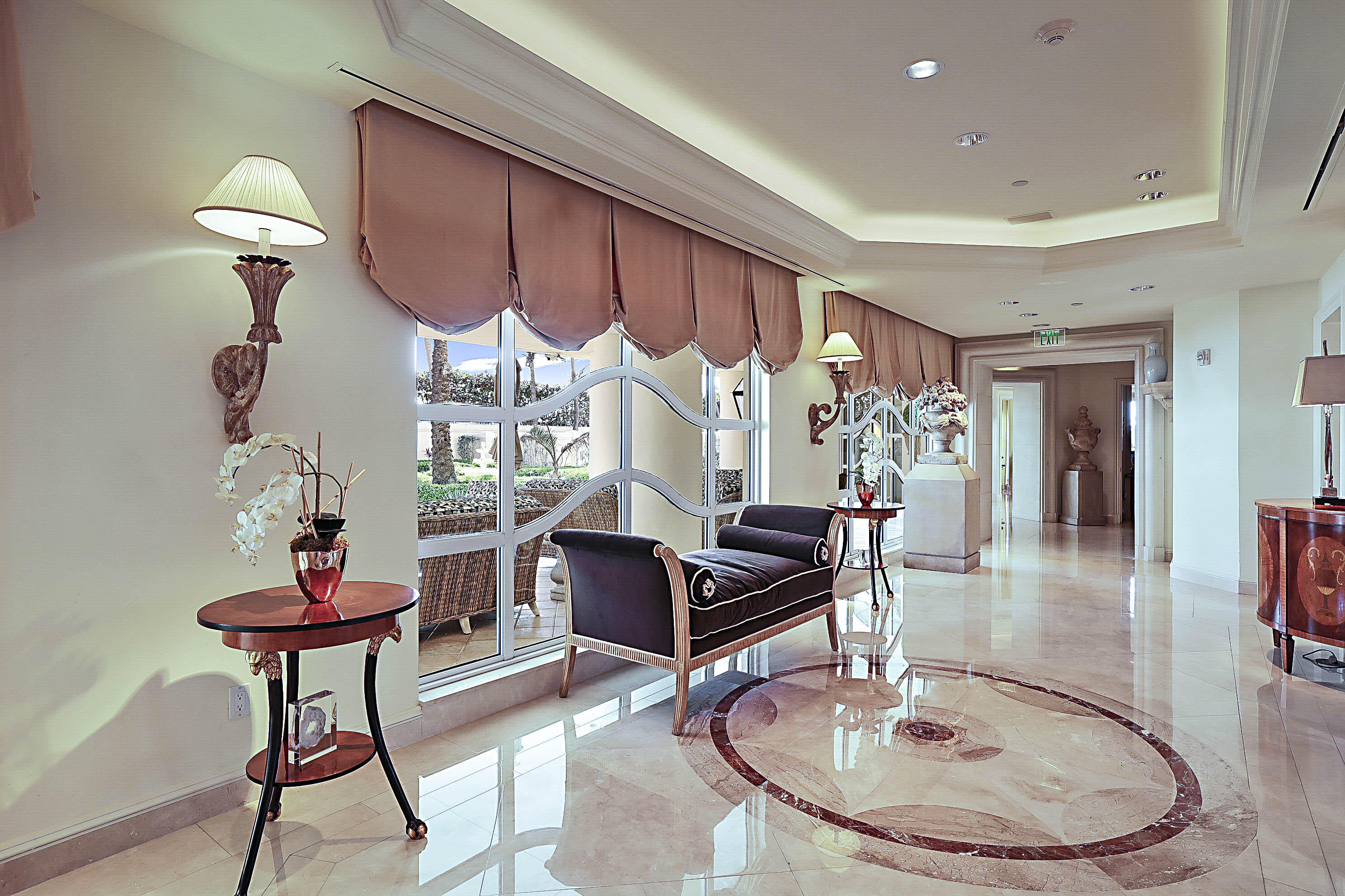 19950 South Beach Road, Unit 4 Tequesta, FL 33469 - Photo 39 of 56 a living room with furniture a piano and a chandelier