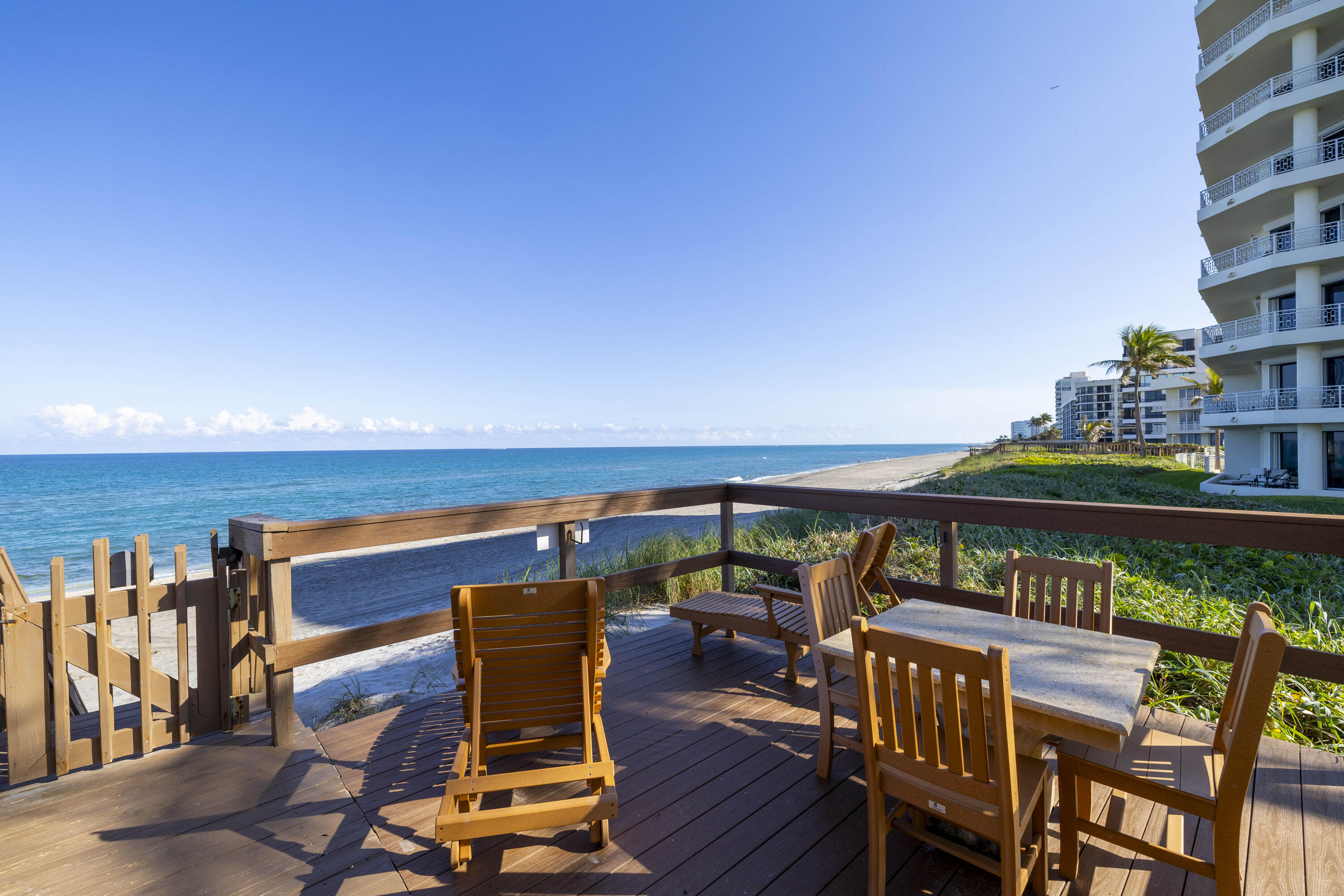 19950 South Beach Road, Unit 4 Tequesta, FL 33469 - Photo 45 of 56 a view of a chairs and table on the terrace