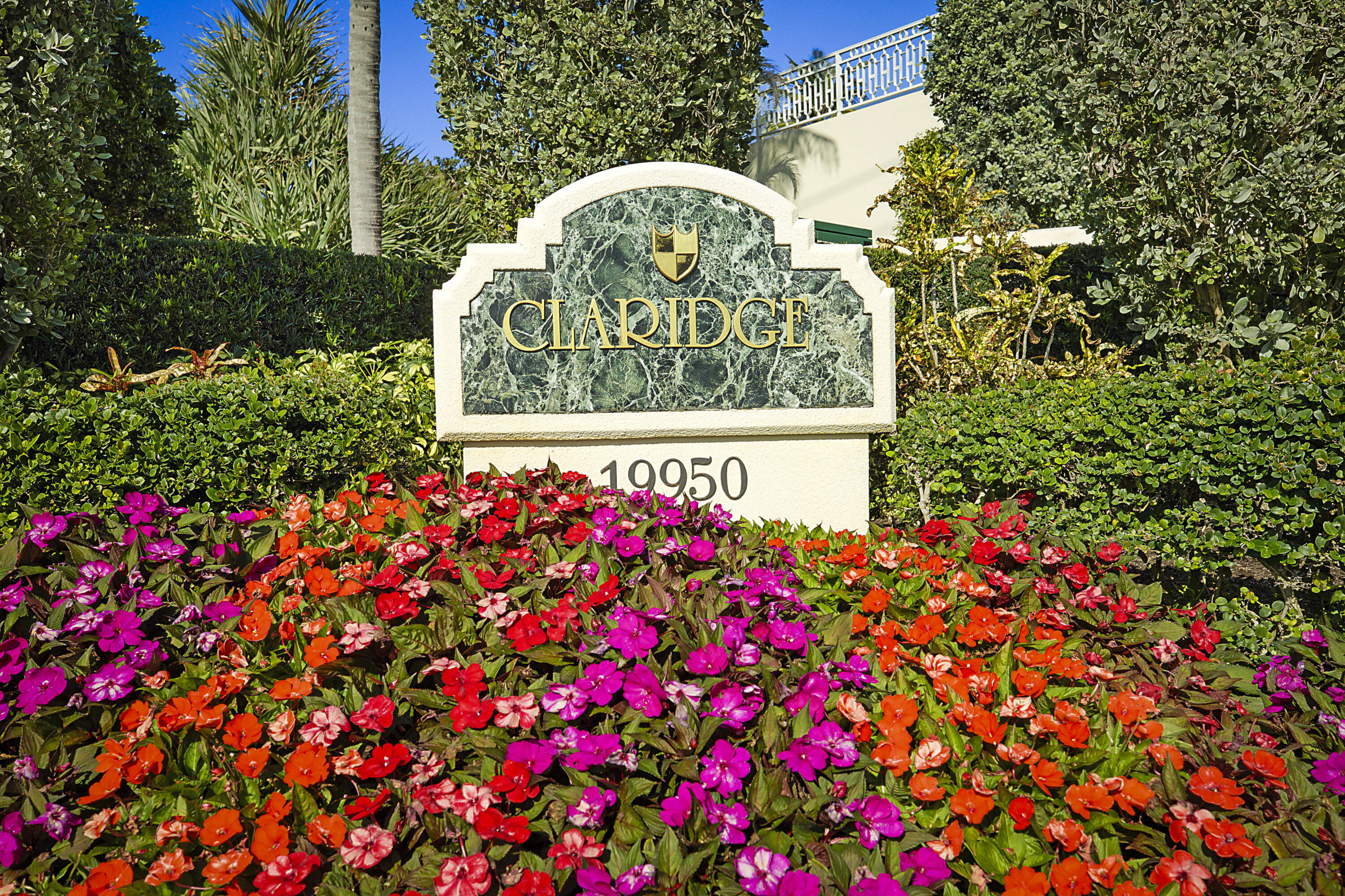 19950 South Beach Road, Unit 4 Tequesta, FL 33469 - Photo 56 of 56 a sign that is sitting in front of flowers