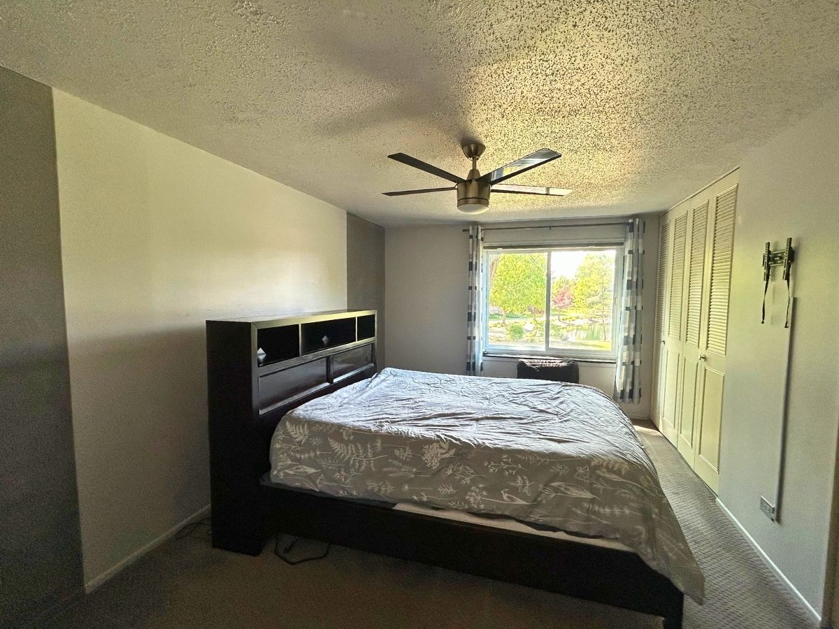 1206 New Wilke Road, Unit 206 Arlington Heights, IL 60005 - Photo 11 of 17 a bedroom with a bed and a window
