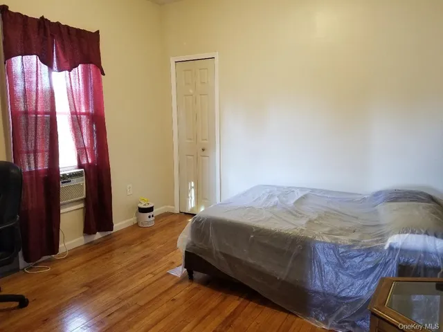 a bedroom with a bed and a mirror