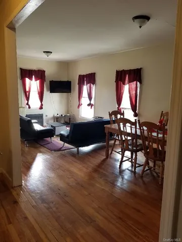 a living room with furniture dining room and wooden floor