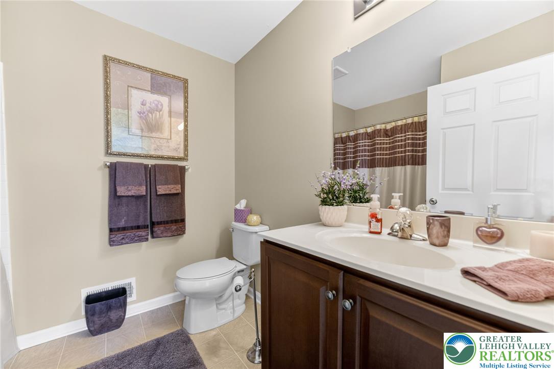 5440 Spring Ridge Drive West Macungie, PA 18062 - Photo 27 of 40 An inviting bathroom offers a well-lit vanity, toilet, and ample space for daily routines.