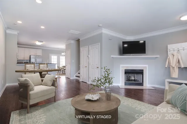 a living room with furniture a fireplace and a flat screen tv