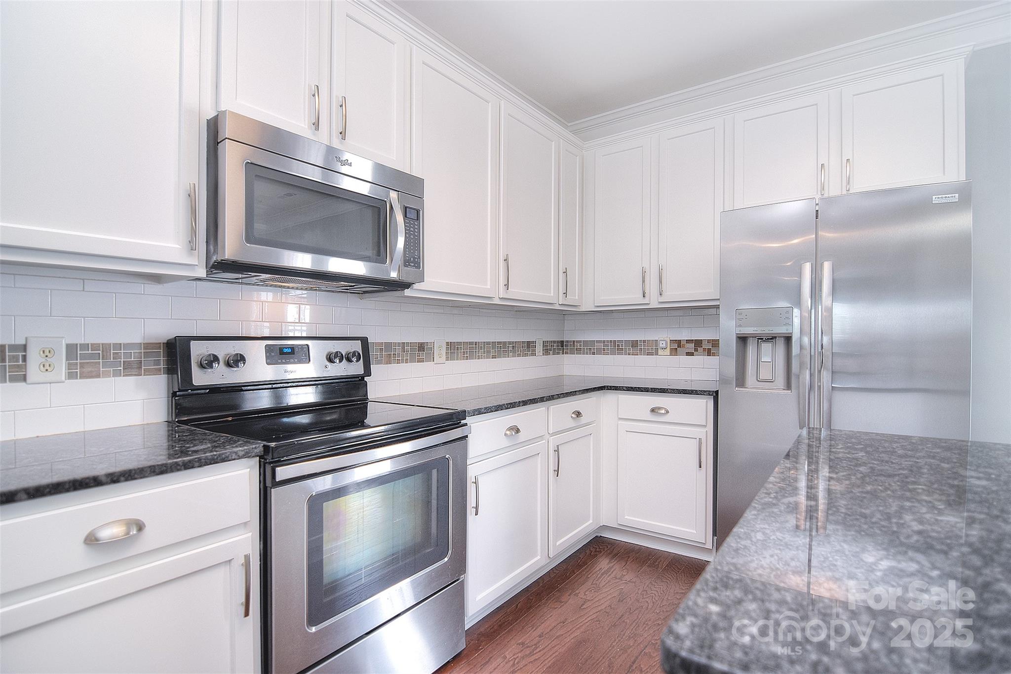 7002 Creft Circle Indian Trail, NC 28079 - Photo 12 of 47 a kitchen with stainless steel appliances granite countertop a stove microwave and refrigerator