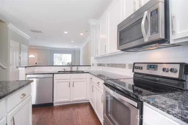 a kitchen with a stove microwave and sink