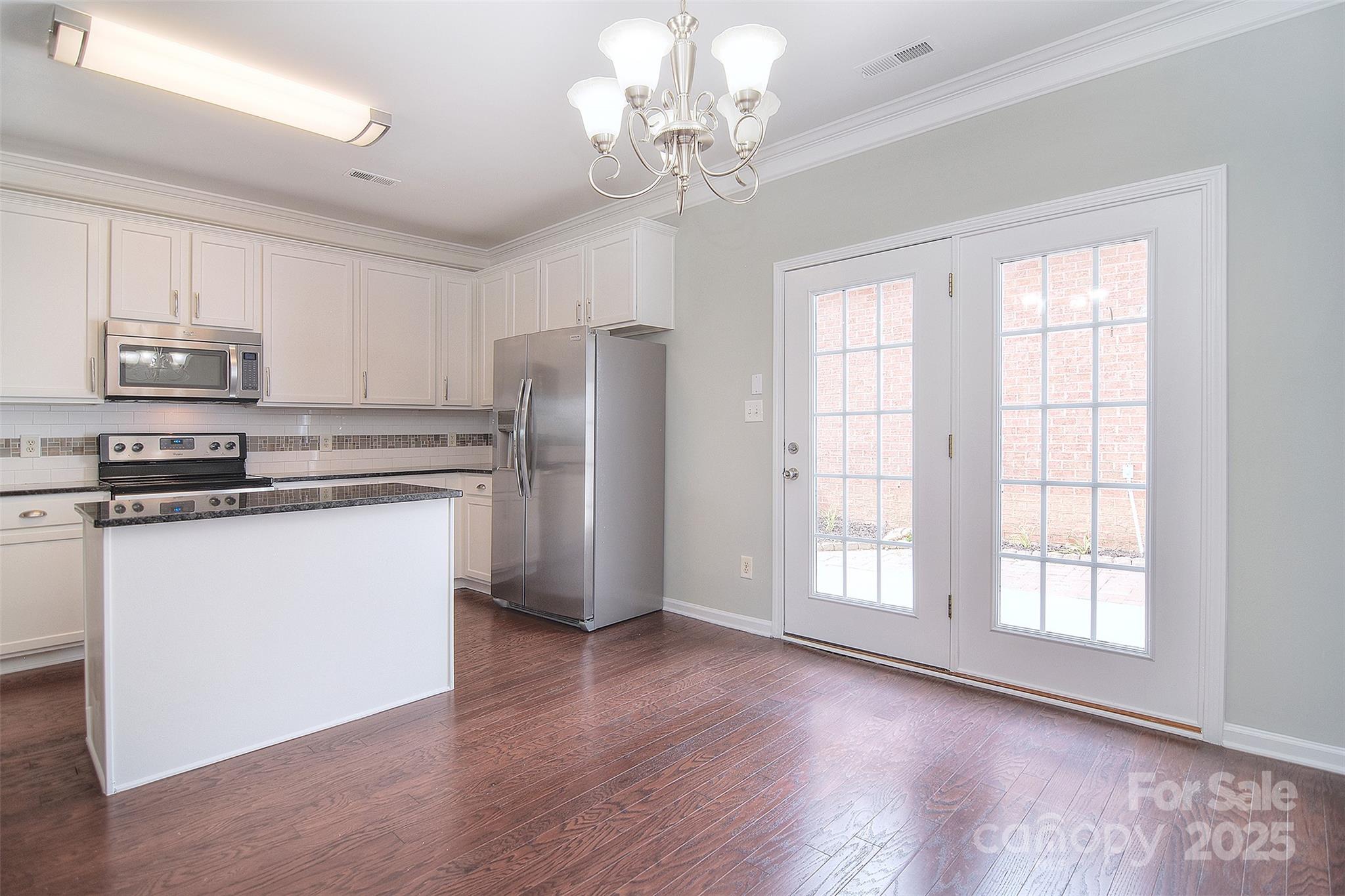 7002 Creft Circle Indian Trail, NC 28079 - Photo 16 of 47 a kitchen with stainless steel appliances granite countertop a refrigerator a stove a sink dishwasher and a refrigerator with wooden floor