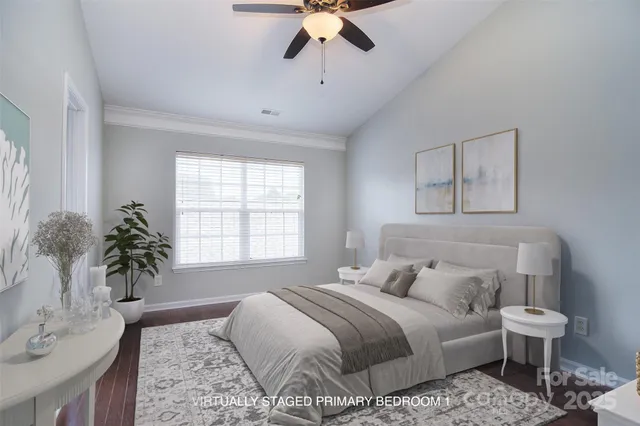 a bedroom with a large bed and a chandelier
