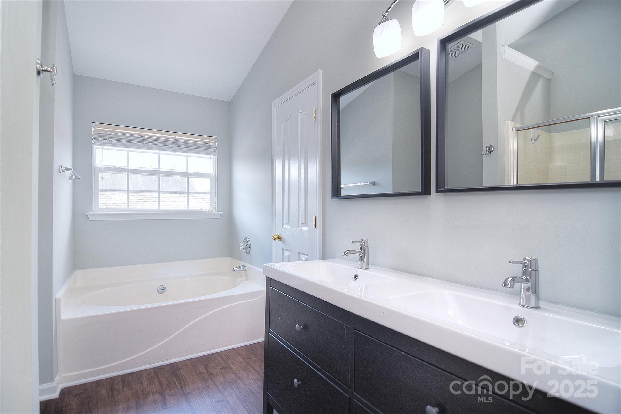7002 Creft Circle Indian Trail, NC 28079 - Photo 23 of 47 a bathroom with a tub sink and mirror