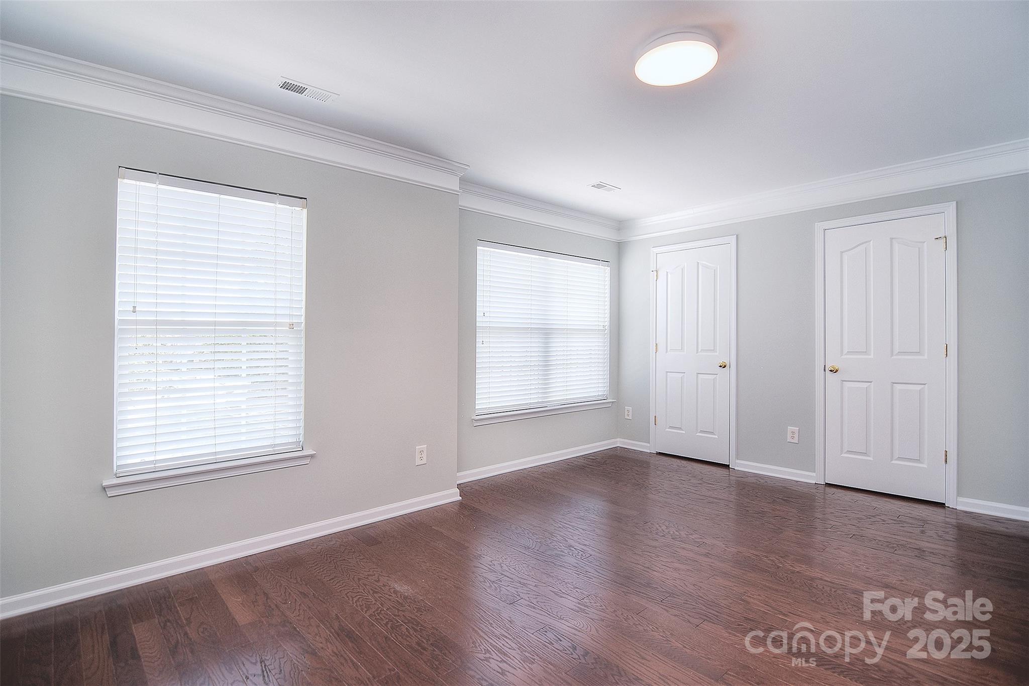 7002 Creft Circle Indian Trail, NC 28079 - Photo 26 of 47 an empty room with wooden floor and windows