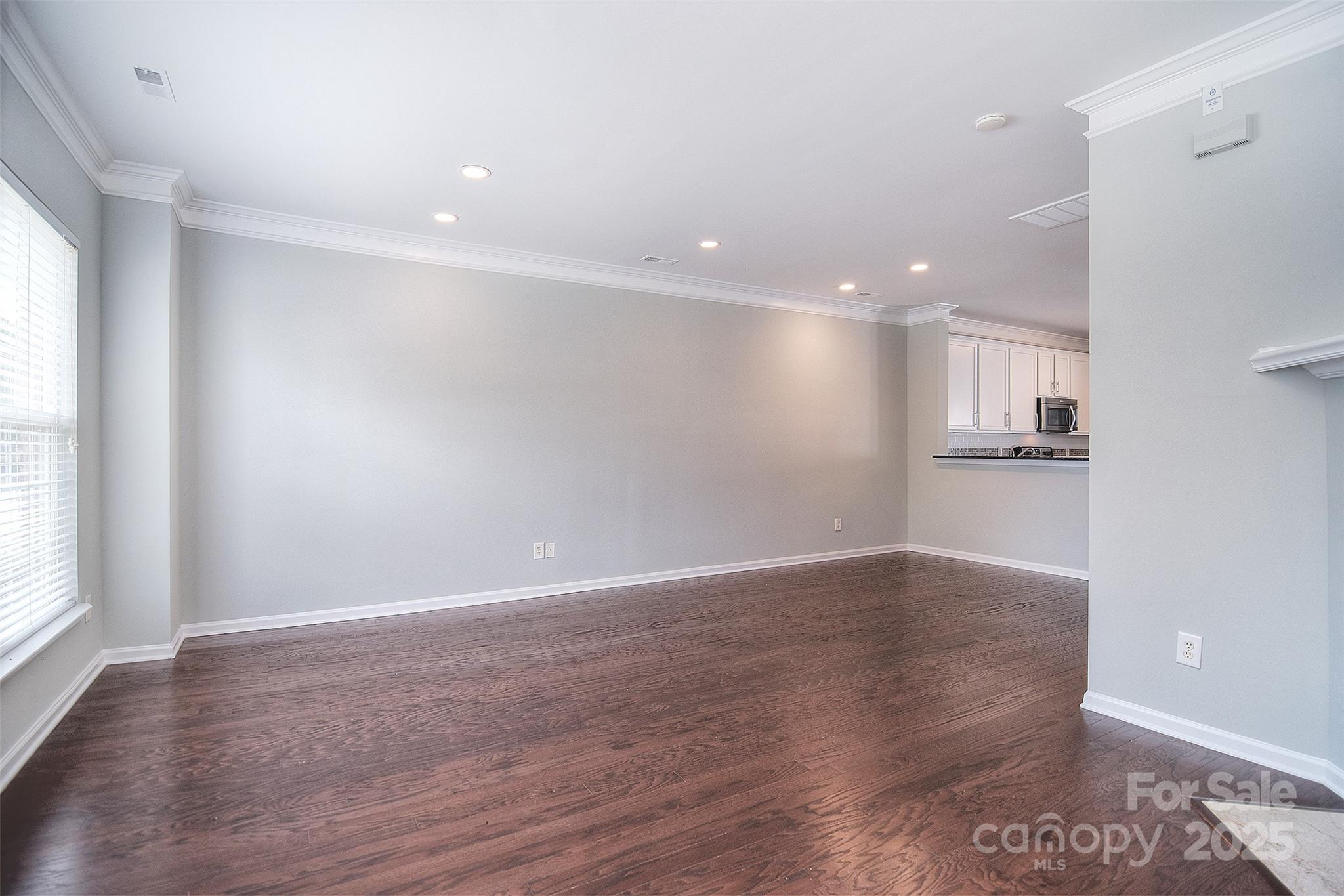 7002 Creft Circle Indian Trail, NC 28079 - Photo 7 of 47 an empty room with wooden floor and windows