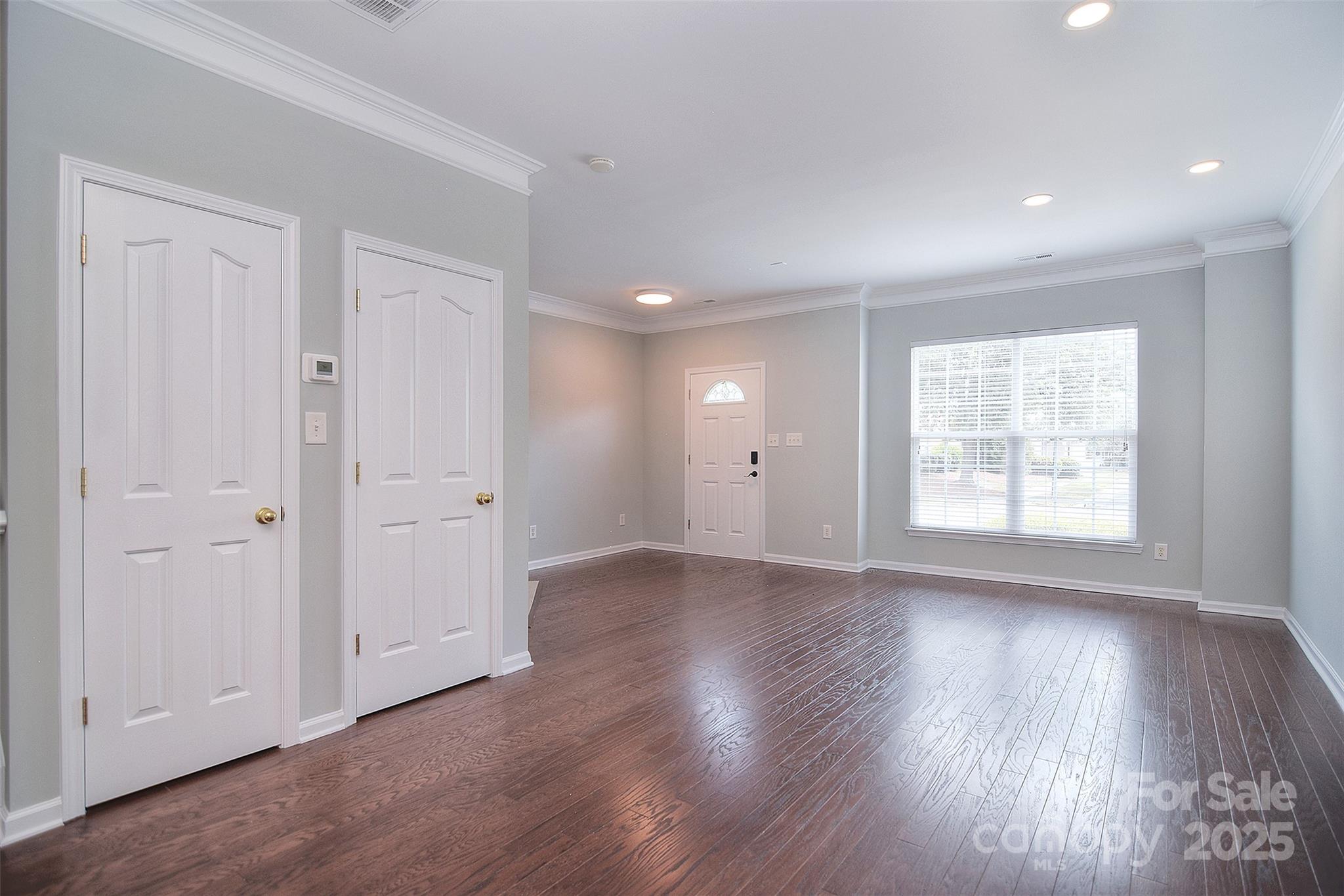 7002 Creft Circle Indian Trail, NC 28079 - Photo 9 of 47 an empty room with wooden floor and windows
