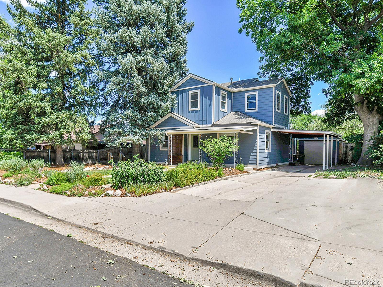 3282 Depew Street Wheat Ridge, CO 80212 - Photo 2 of 50 a front view of a house with a garden