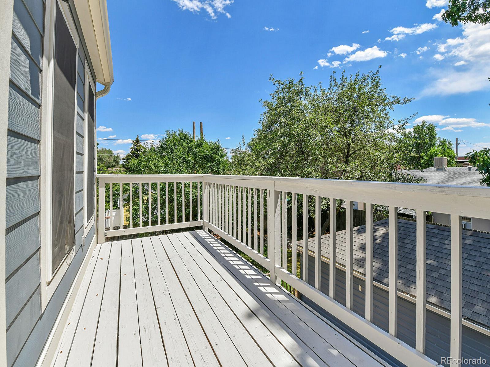 3282 Depew Street Wheat Ridge, CO 80212 - Photo 23 of 50 a view of a balcony with wooden floor and fence