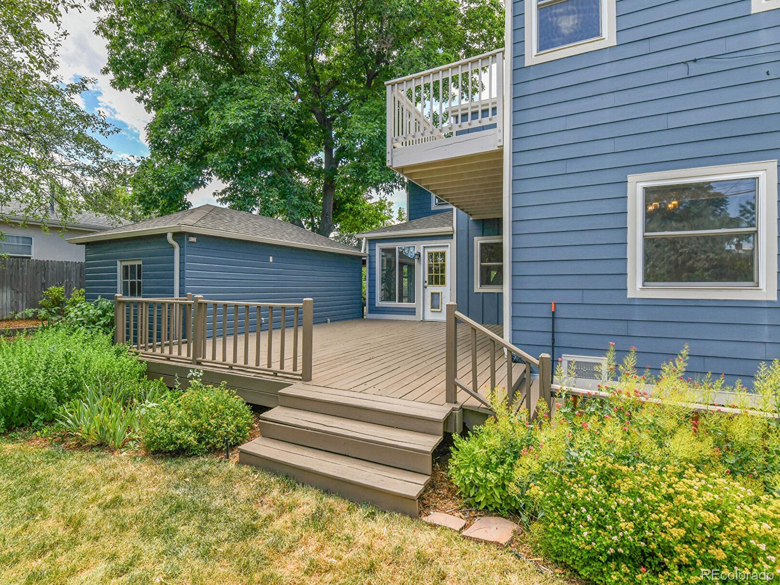 3282 Depew Street Wheat Ridge, CO 80212 - Photo 43 of 50 a view of a house with a small yard and flower plants