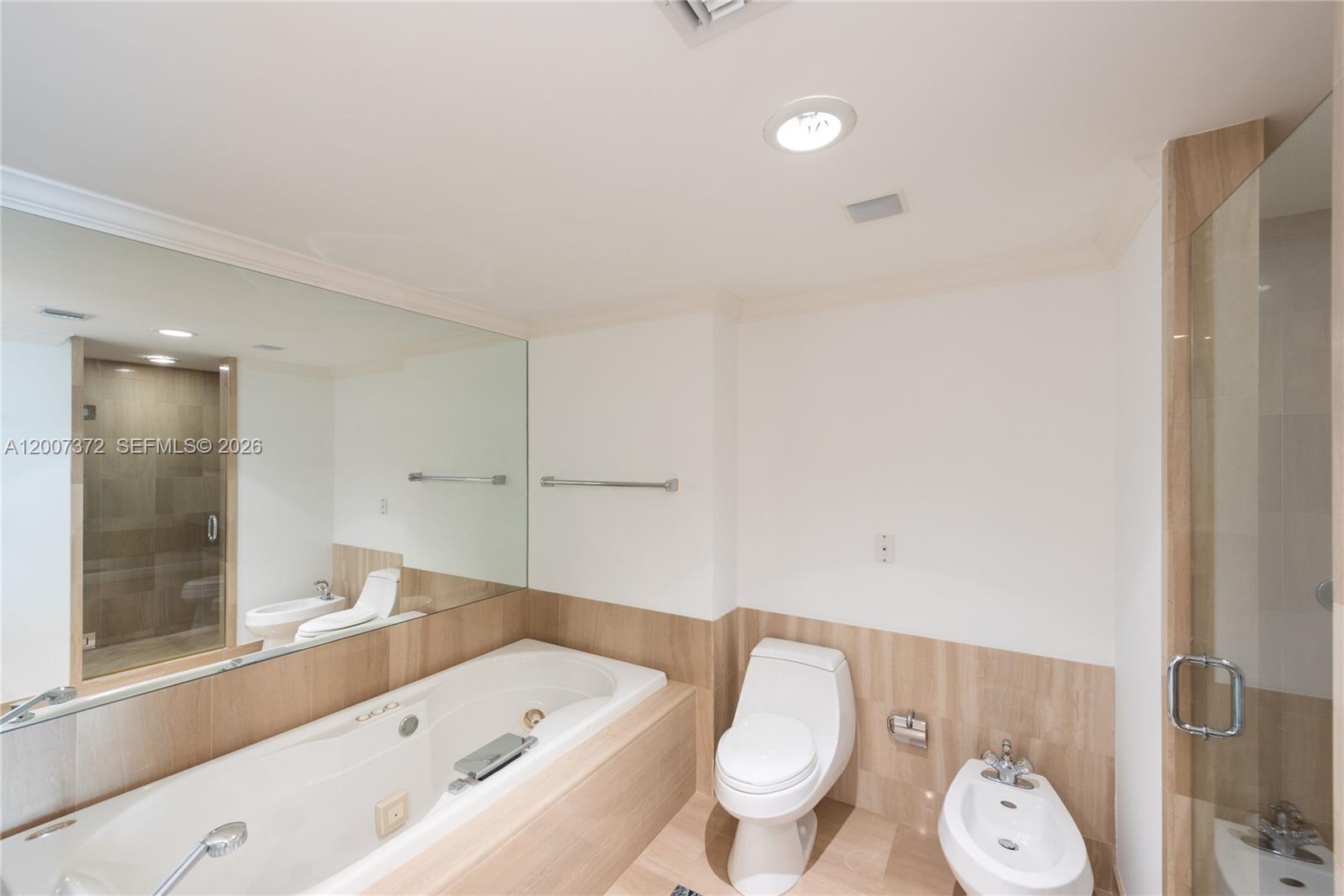 1643 Brickell Avenue, Unit 1103 Miami, FL 33129 - Photo 12 of 32 a bathroom with a toilet a sink and a bathtub