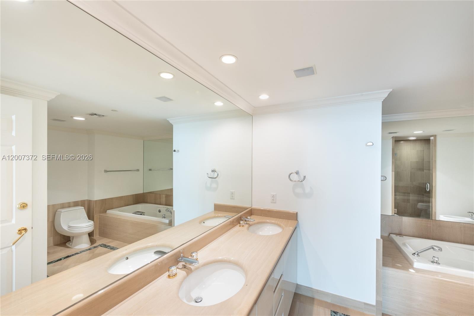 1643 Brickell Avenue, Unit 1103 Miami, FL 33129 - Photo 13 of 32 a bathroom with a granite countertop sink mirror vanity and bathtub
