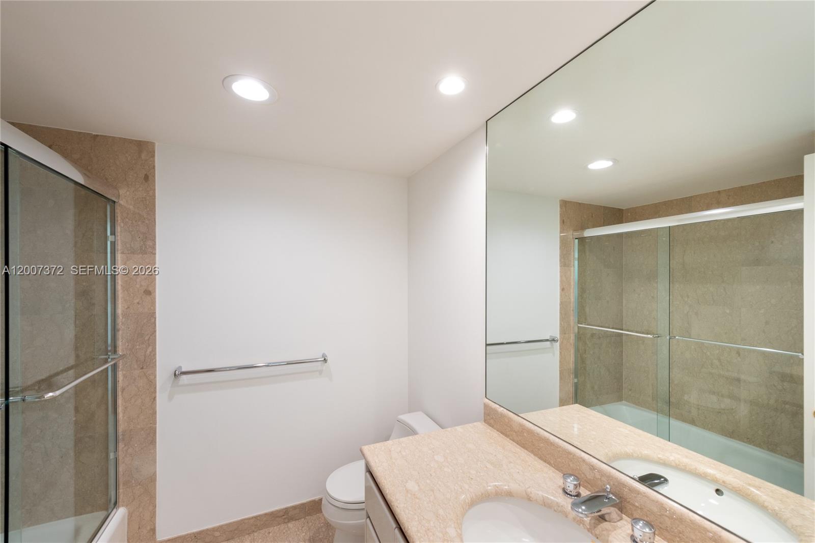1643 Brickell Avenue, Unit 1103 Miami, FL 33129 - Photo 17 of 32 a bathroom with a sink and a mirror