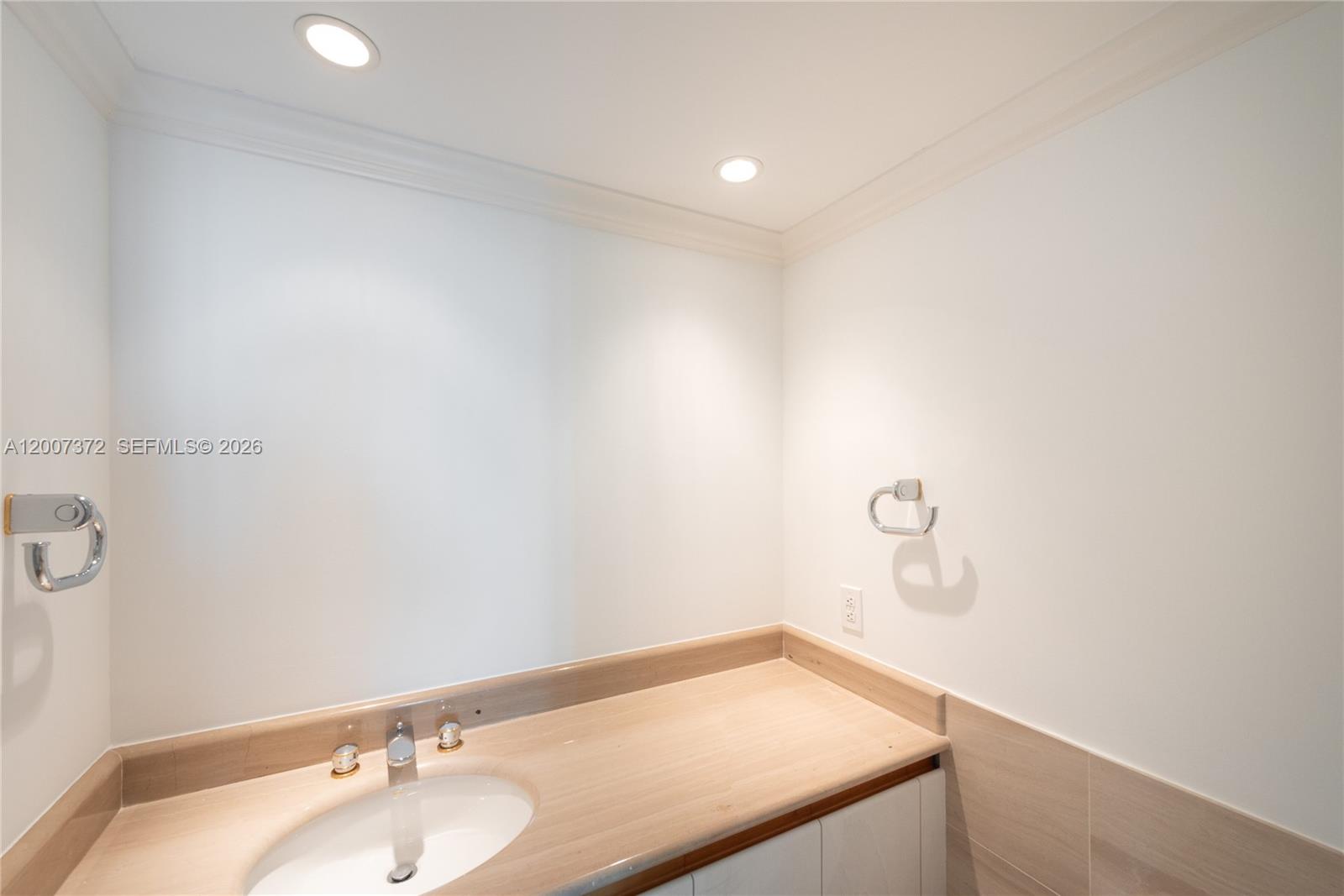 1643 Brickell Avenue, Unit 1103 Miami, FL 33129 - Photo 18 of 32 a bathroom with a sink and vanity