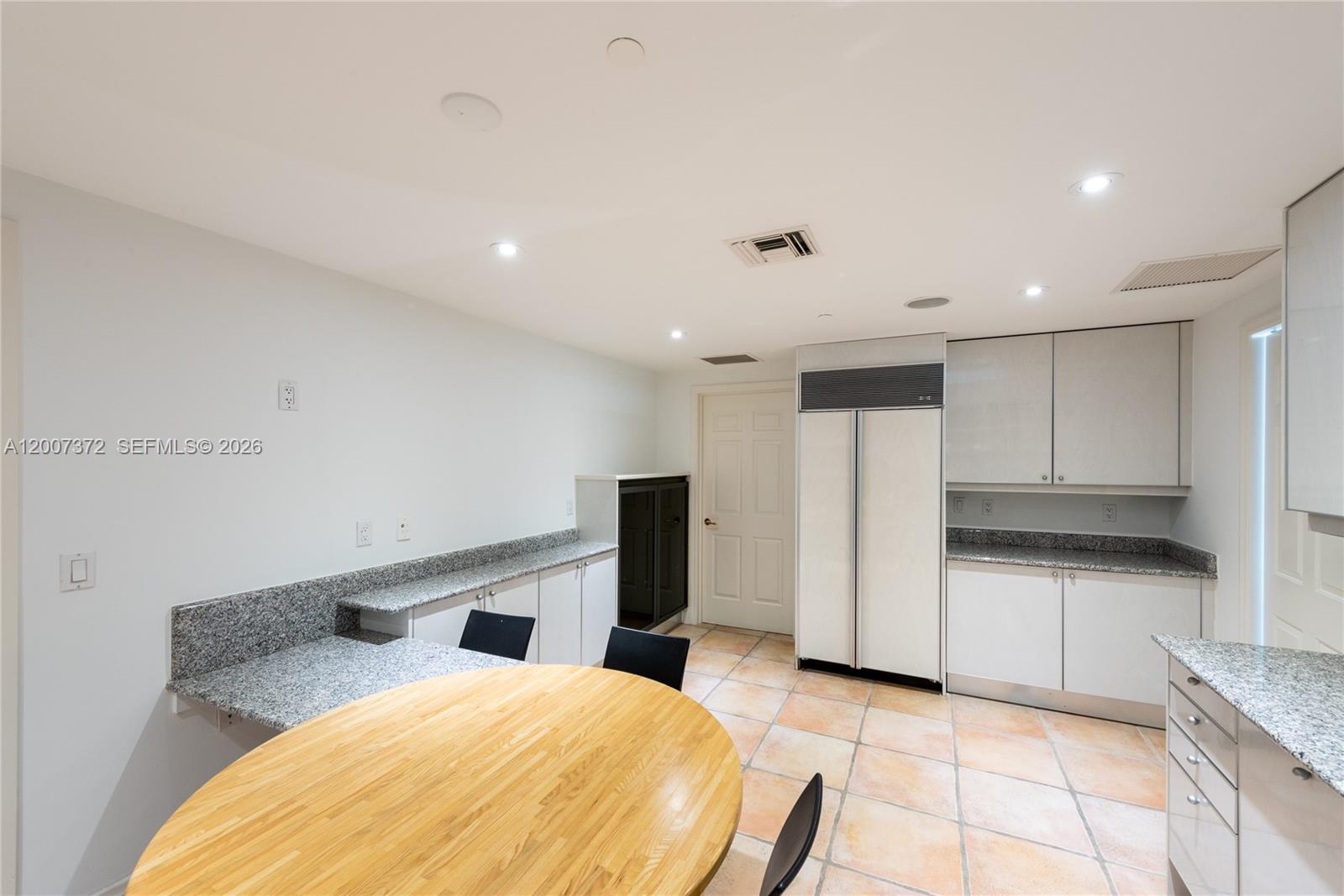 1643 Brickell Avenue, Unit 1103 Miami, FL 33129 - Photo 21 of 32 a large white kitchen with cabinets