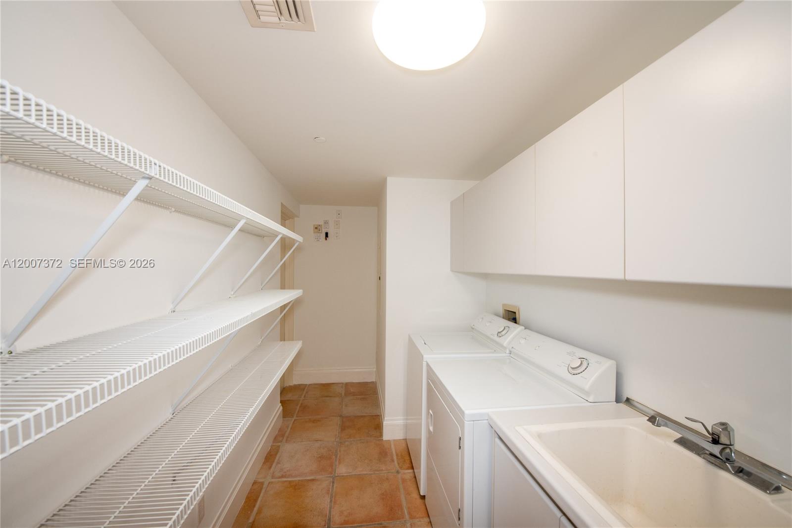 1643 Brickell Avenue, Unit 1103 Miami, FL 33129 - Photo 22 of 32 a bathroom with a sink and a washing machine