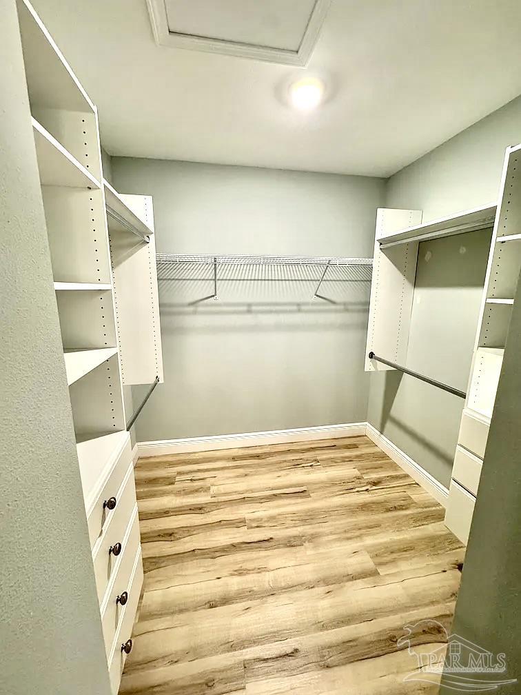 1910 West Kingsfield Road Cantonment, FL 32533 - Photo 5 of 8 a view of walk in closet with empty racks