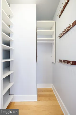 a view of walk in closet with empty racks