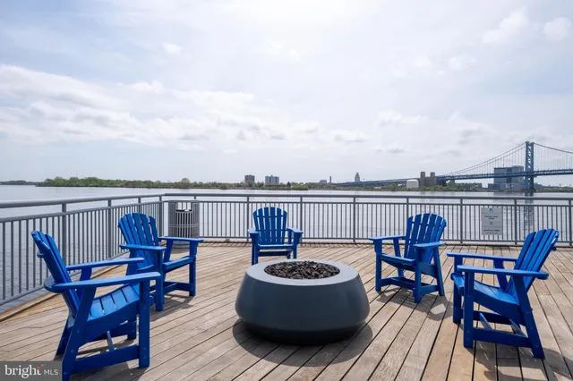 a view of a living room with furniture and floor to ceiling windows