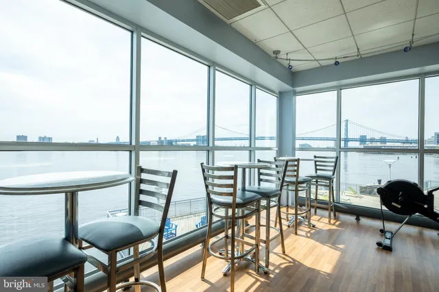 a living room with fireplace furniture and a large window
