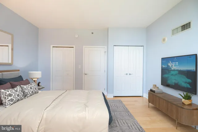 a bedroom with a bed and a flat screen tv