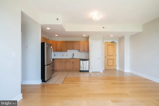 a view of a kitchen with a refrigerator and a sink