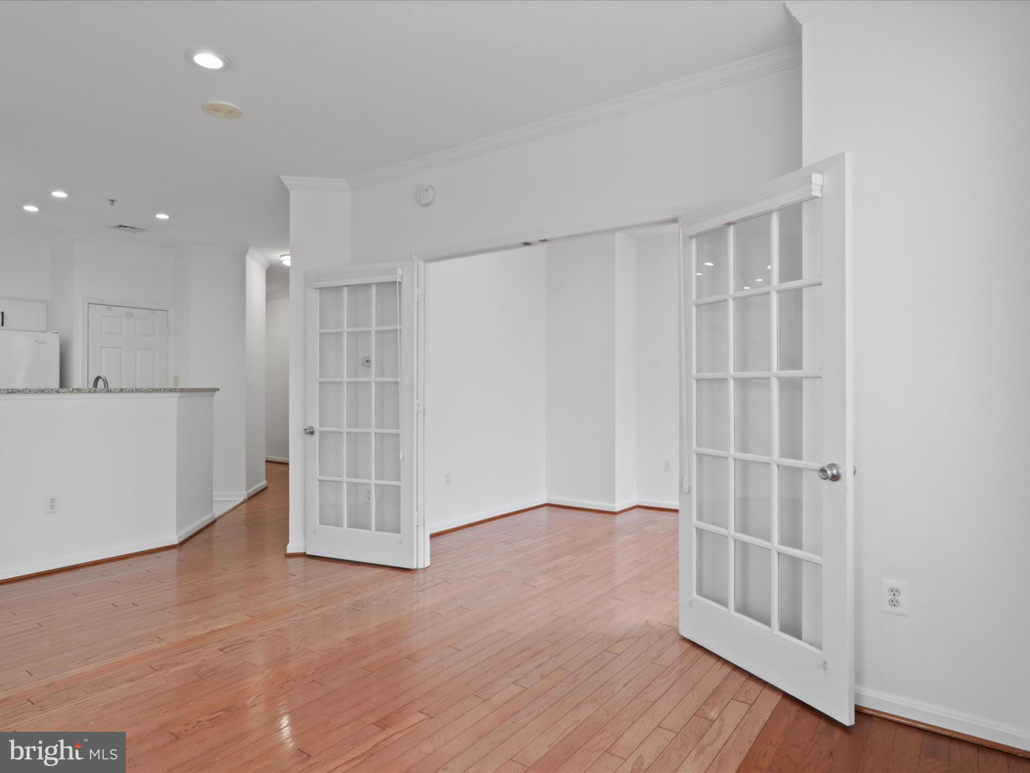 3830 9th Street North, Unit PH3E Arlington, VA 22203 - Photo 12 of 44 a view of an empty room with wooden floor and a window