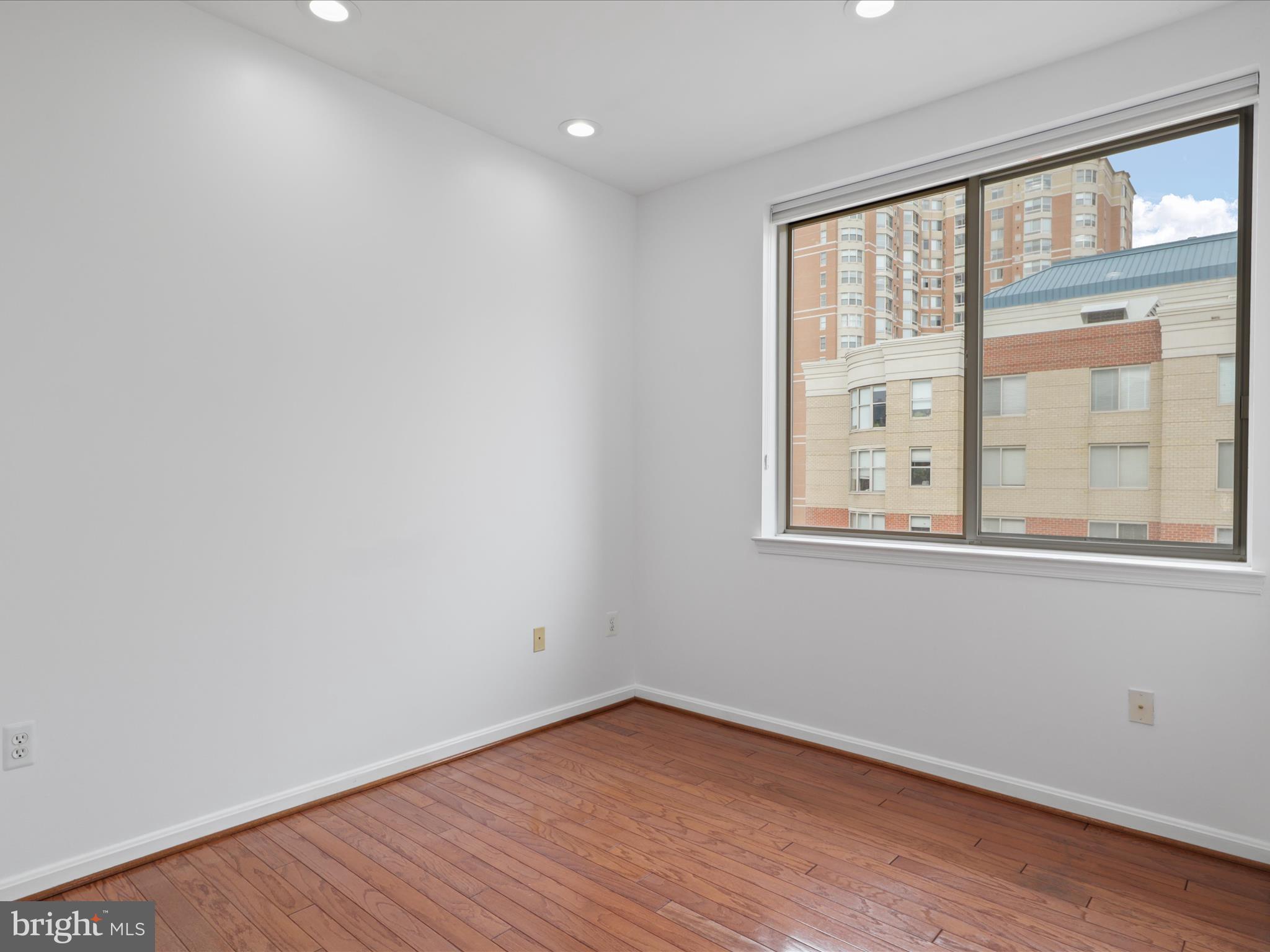 3830 9th Street North, Unit PH3E Arlington, VA 22203 - Photo 14 of 44 an empty room with wooden floor and windows
