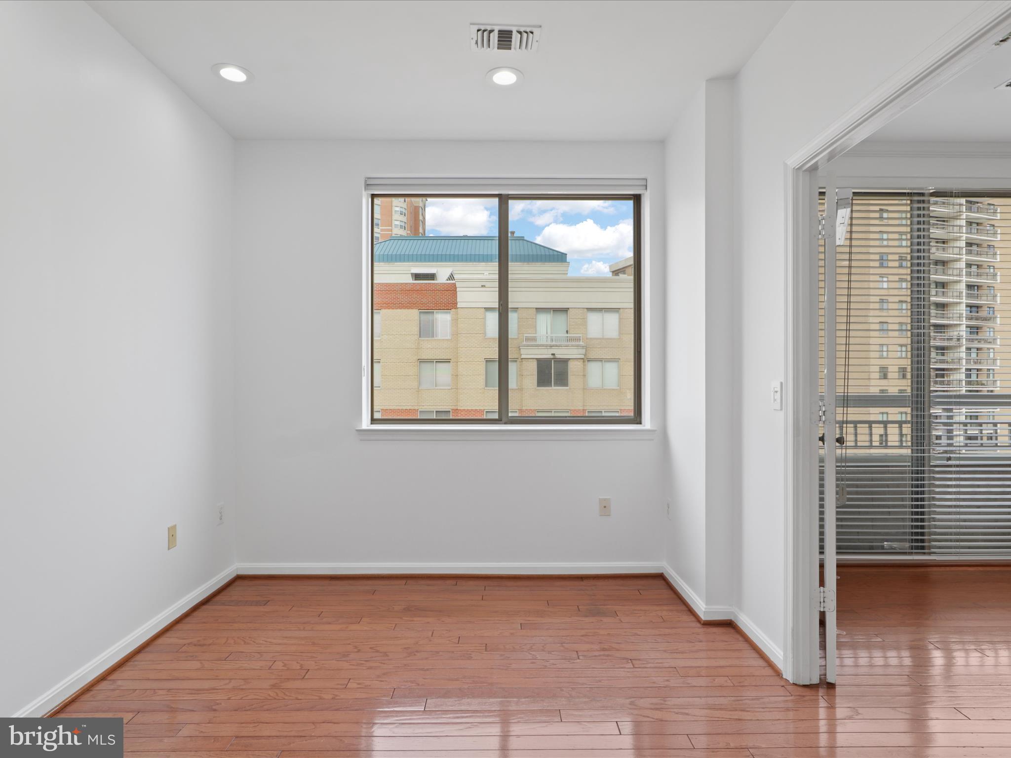 3830 9th Street North, Unit PH3E Arlington, VA 22203 - Photo 15 of 44 an empty room with wooden floor and windows