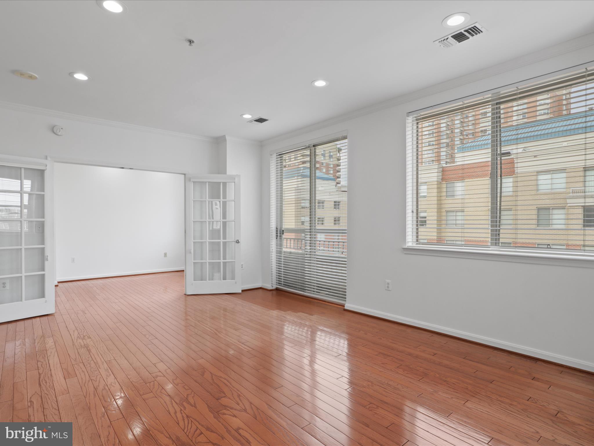 3830 9th Street North, Unit PH3E Arlington, VA 22203 - Photo 20 of 44 a view of an empty room with wooden floor and a window