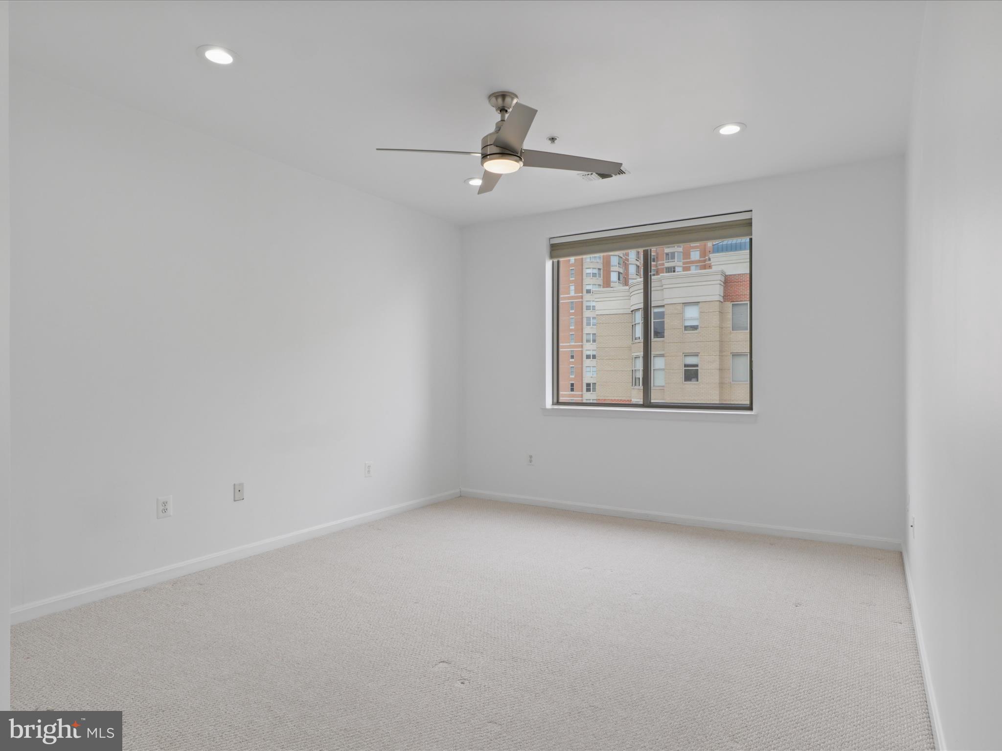 3830 9th Street North, Unit PH3E Arlington, VA 22203 - Photo 22 of 44 an empty room with windows and ceiling fan