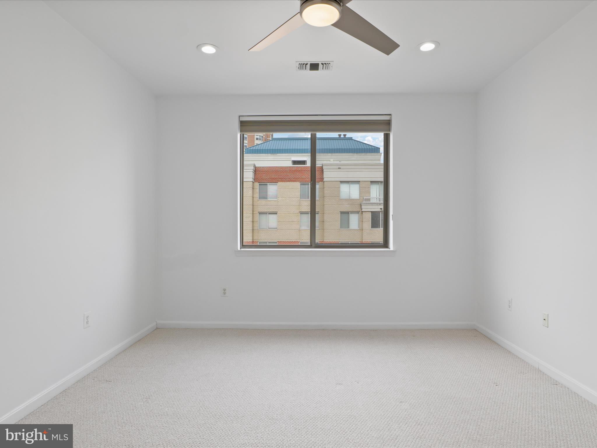 3830 9th Street North, Unit PH3E Arlington, VA 22203 - Photo 23 of 44 an empty room with a window and ceiling fan
