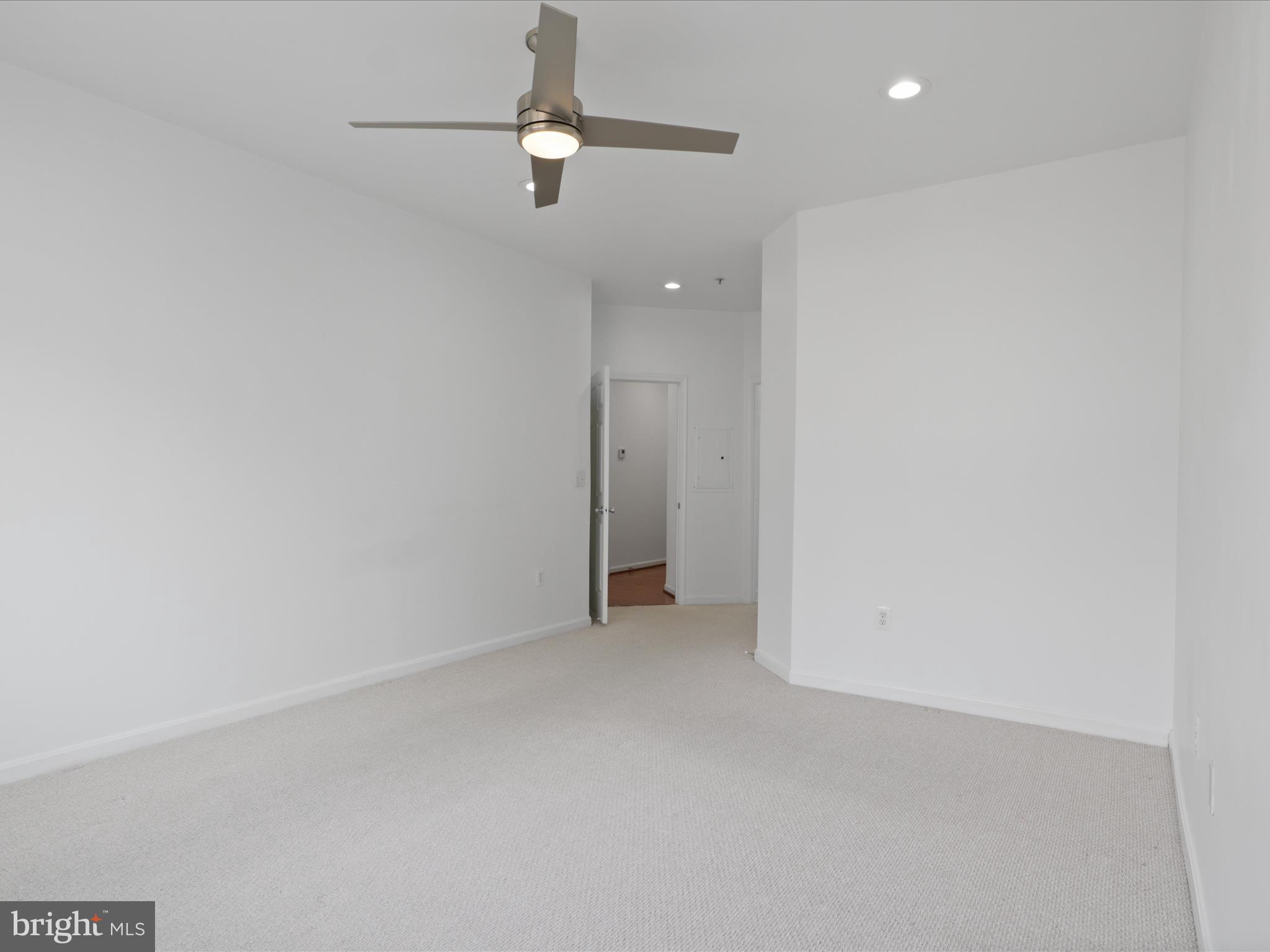 3830 9th Street North, Unit PH3E Arlington, VA 22203 - Photo 24 of 44 an empty room with a ceiling fan and carpet