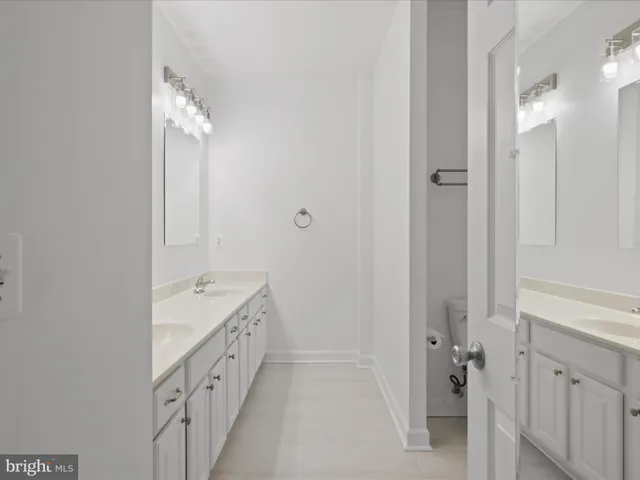 a bathroom with a double vanity sink and mirror